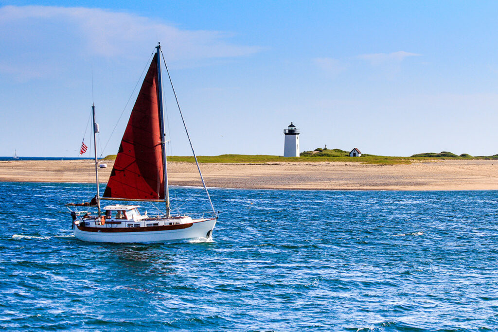 long point light and sailboat